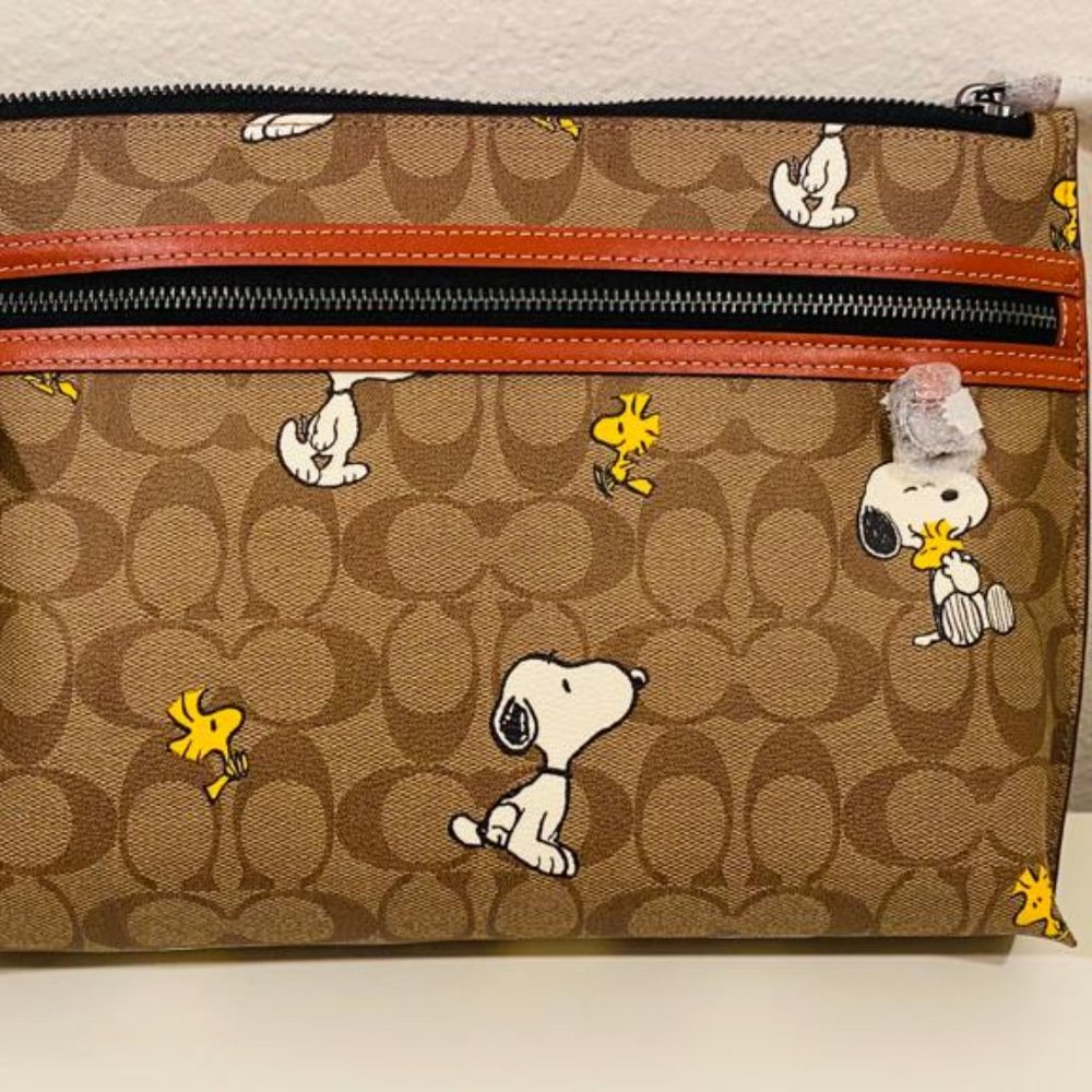 Coach x Peanuts carry all pouch in signature canvas with snoopy woodstock print